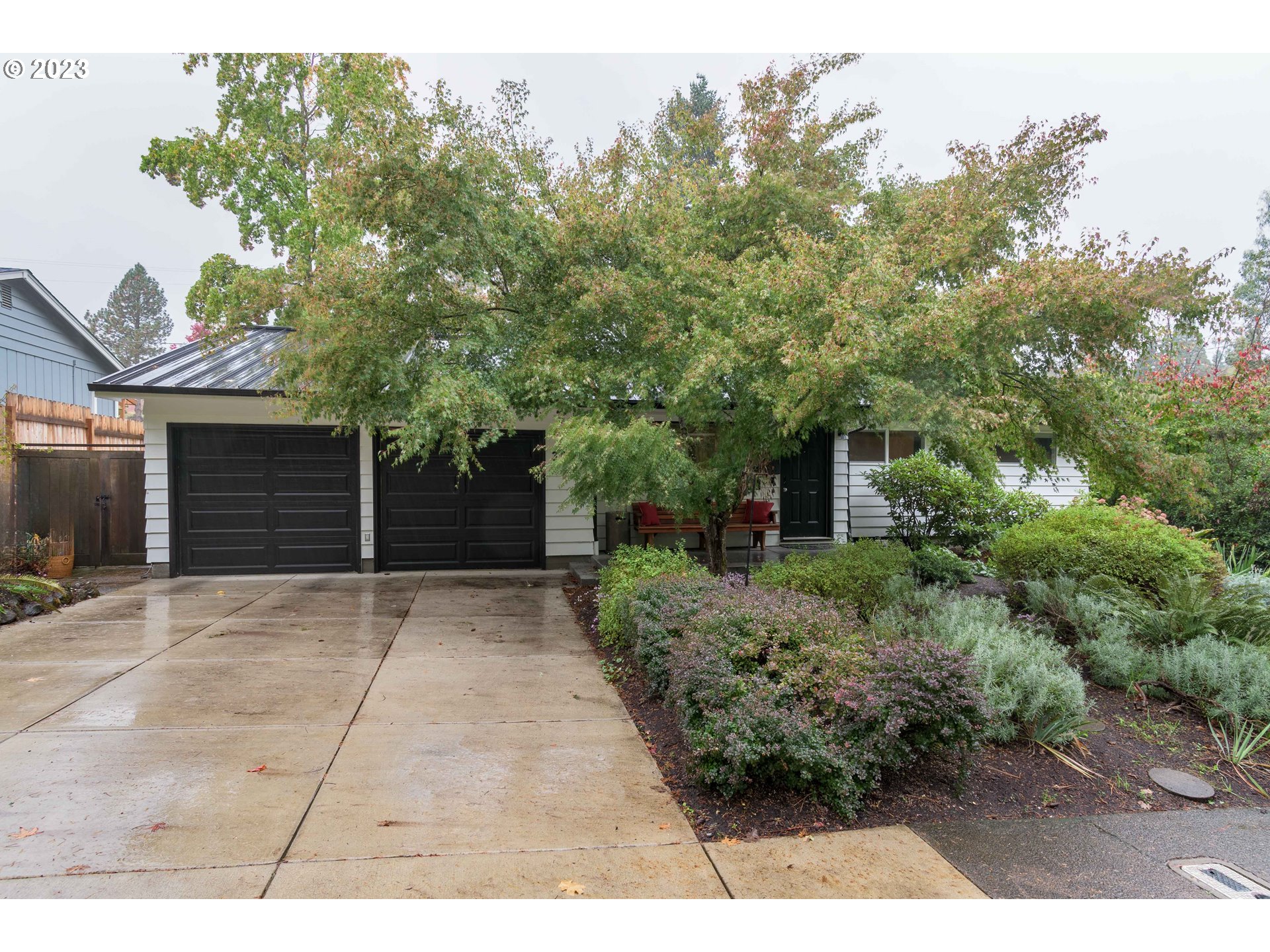 3950 Donald Street Eugene, OR 97405 - Photo 2 of 33 a view of a house with a yard and garage