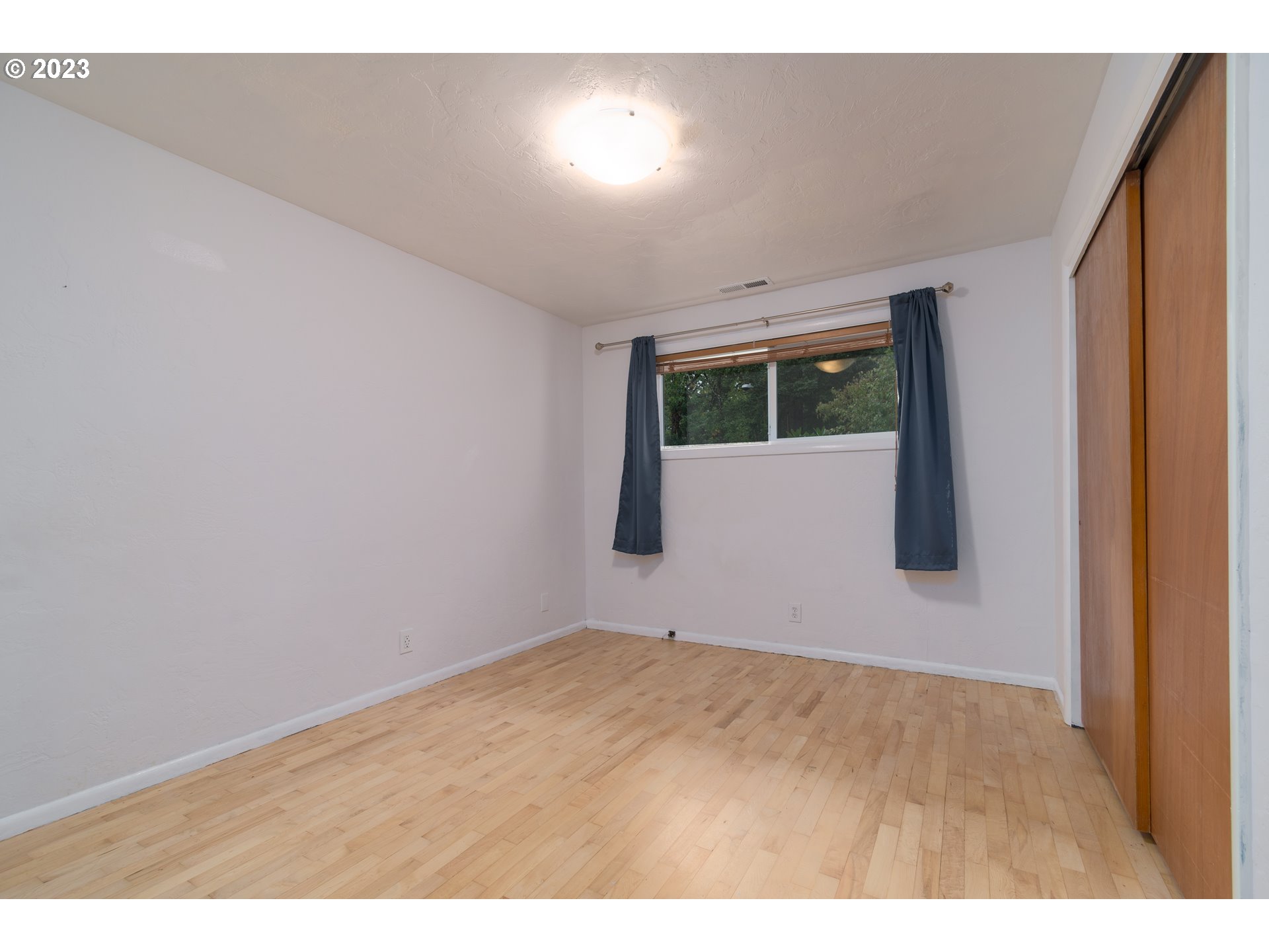 3950 Donald Street Eugene, OR 97405 - Photo 25 of 33 a view of an empty room with wooden floor and a window