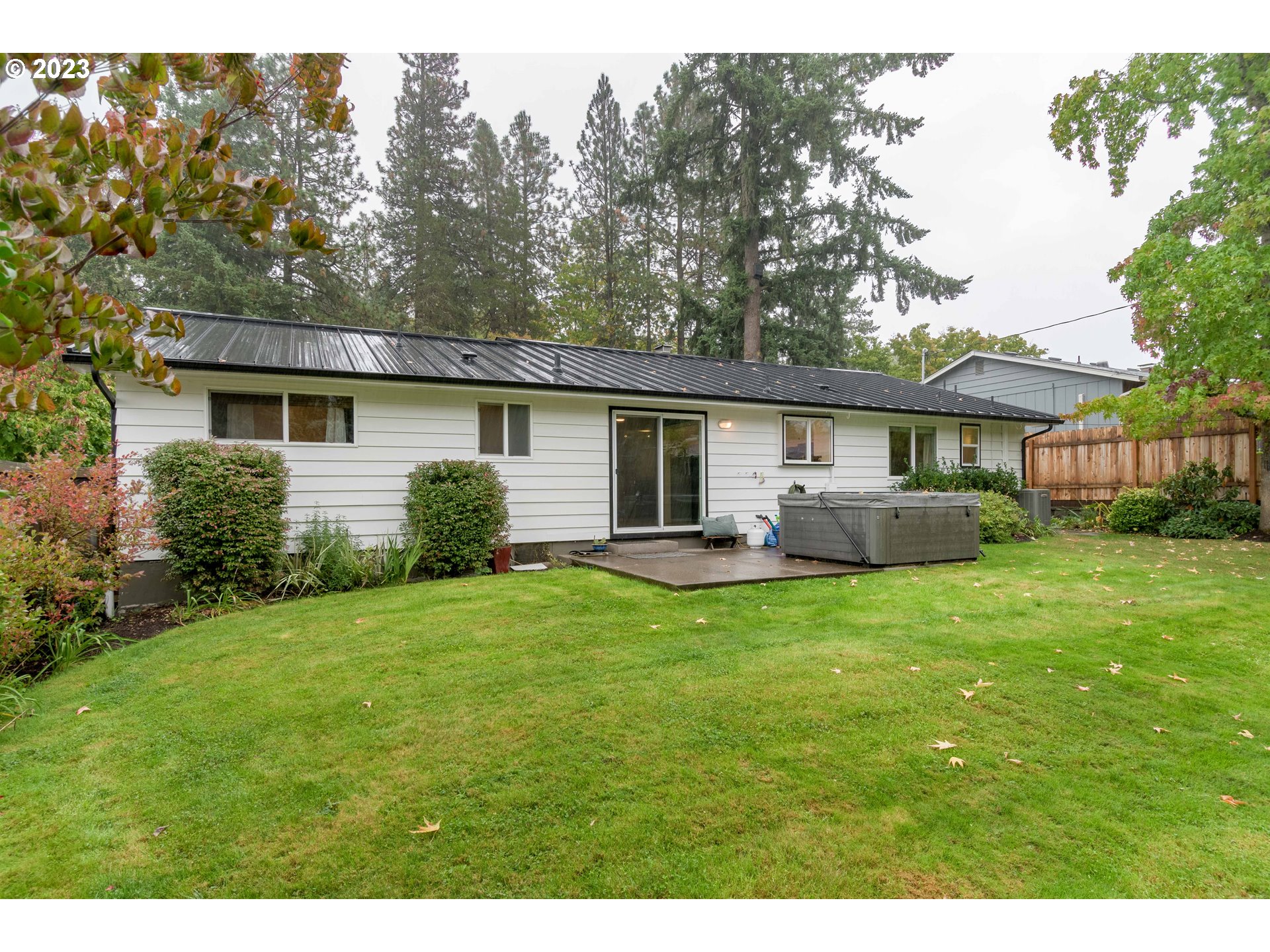 3950 Donald Street Eugene, OR 97405 - Photo 32 of 33 a view of a house with a backyard and a patio