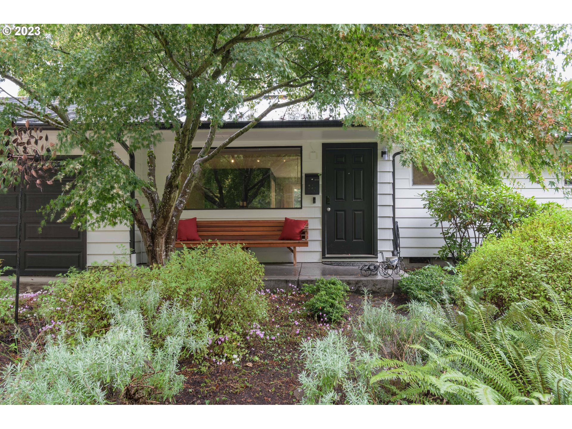 3950 Donald Street Eugene, OR 97405 - Photo 4 of 33 a view of a house with a small yard plants and large tree