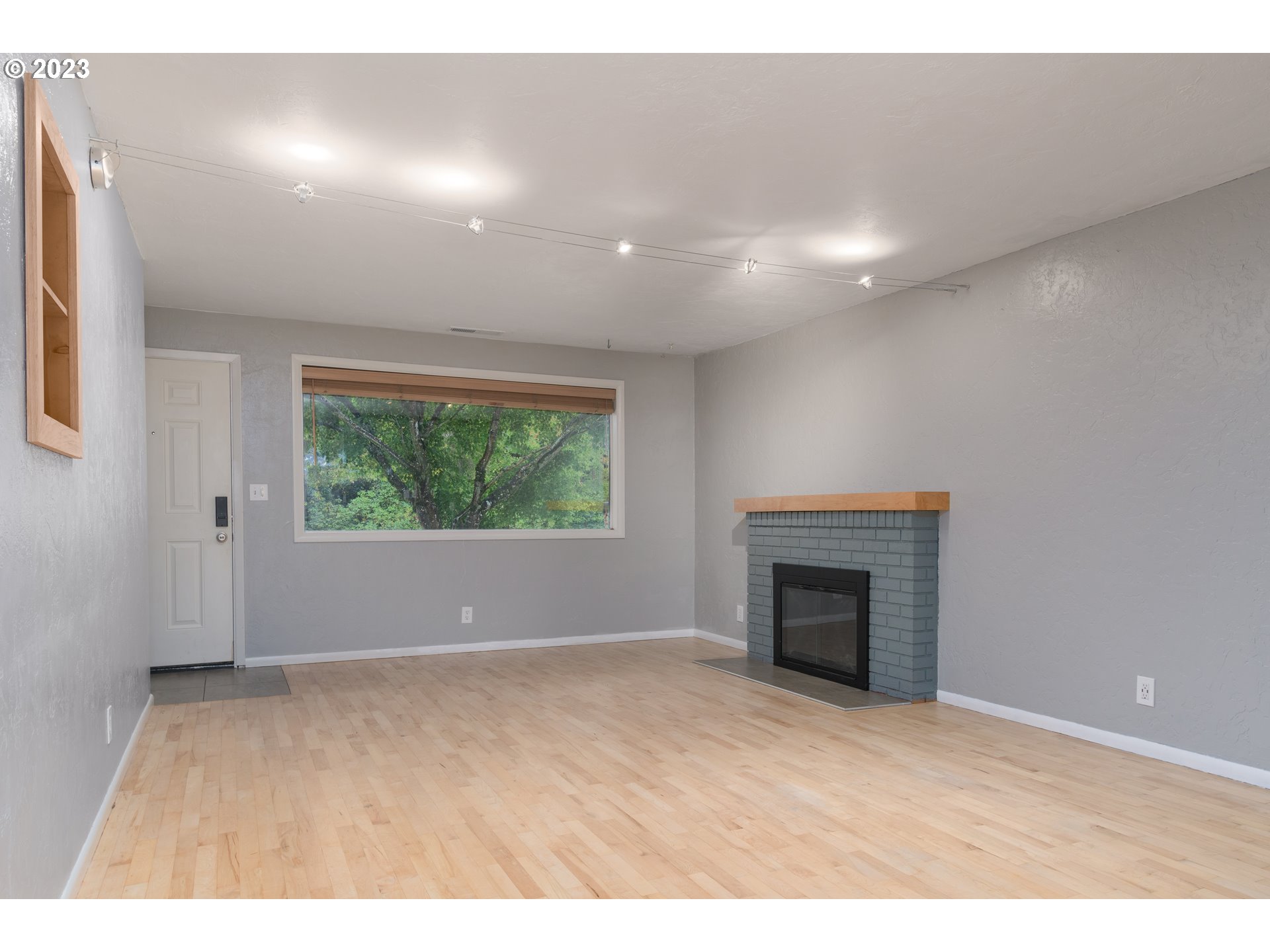 3950 Donald Street Eugene, OR 97405 - Photo 9 of 33 a view of an empty room with a fireplace and a window