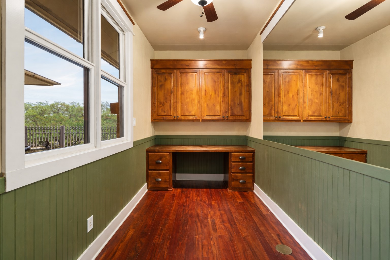 23426 Oscar Road Spicewood, TX 78669 - Photo 16 of 40 The home has an office with a built-in desk and cabinets. The view features an enclosed courtyard with a bronze water fountain. Seen from the dining area also.