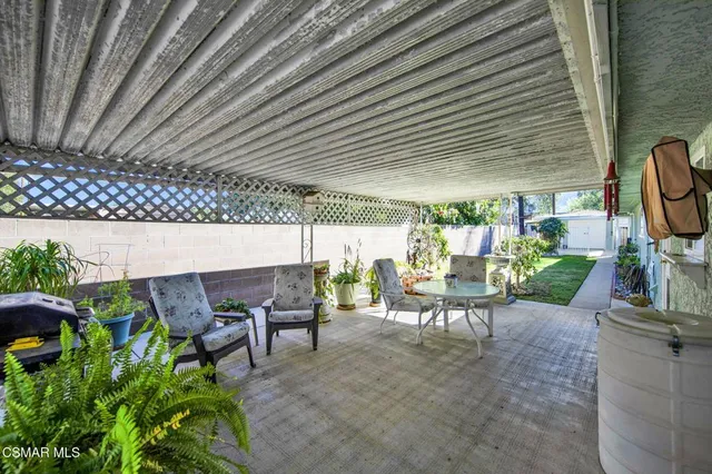 a view of a patio with table and chairs and potted plants