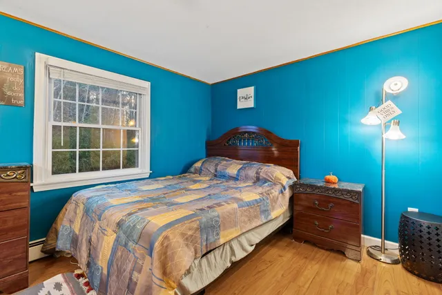 a bedroom with a bed and a lamp