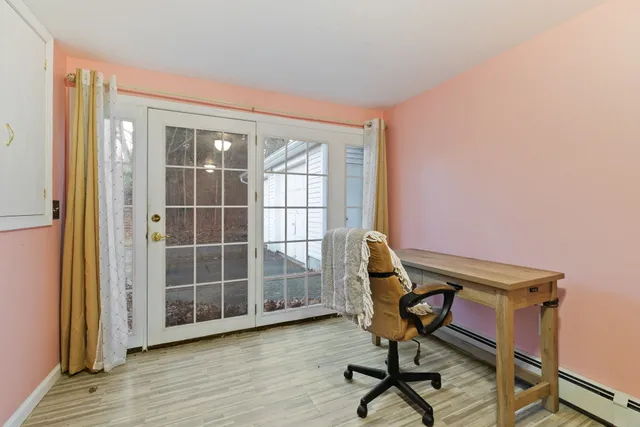 a view of a workspace with furniture and a window