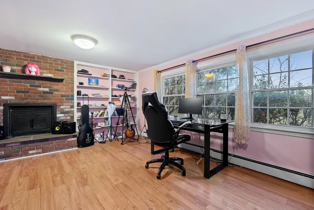 a work room with furniture a rug and a fireplace