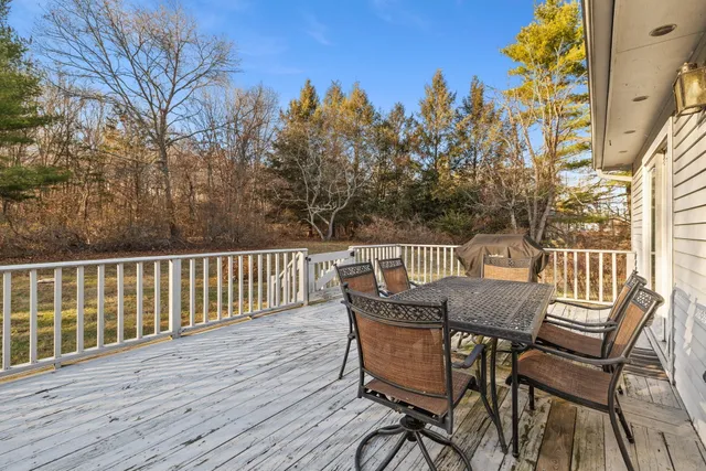 a view of a wooden chairs and table on the wooden deck