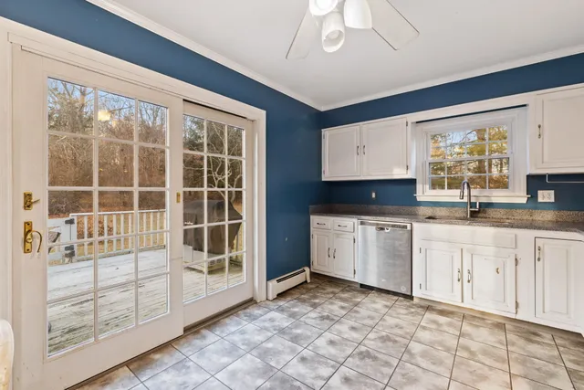a kitchen with granite countertop a stove a sink and a microwave