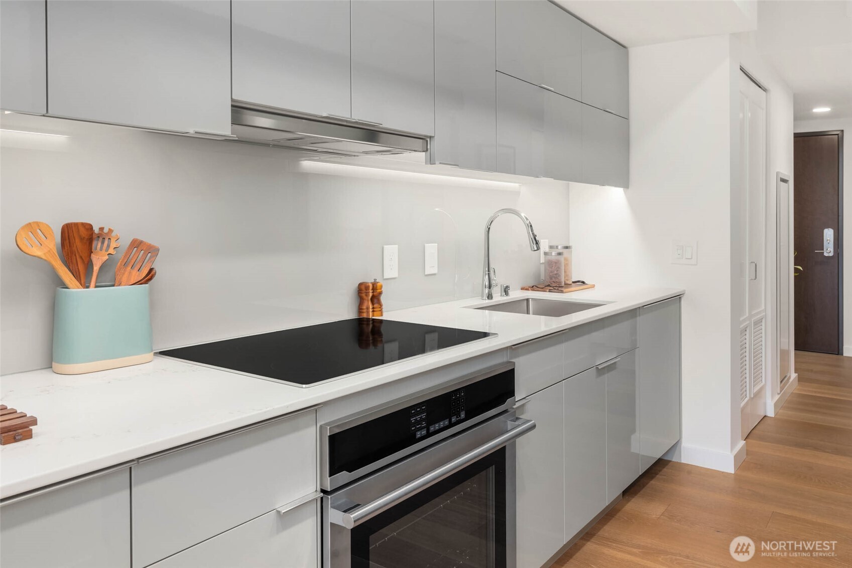 450 South Main Street, Unit 1102 Seattle, WA 98104 - Photo 7 of 26 a kitchen with a sink and cabinets
