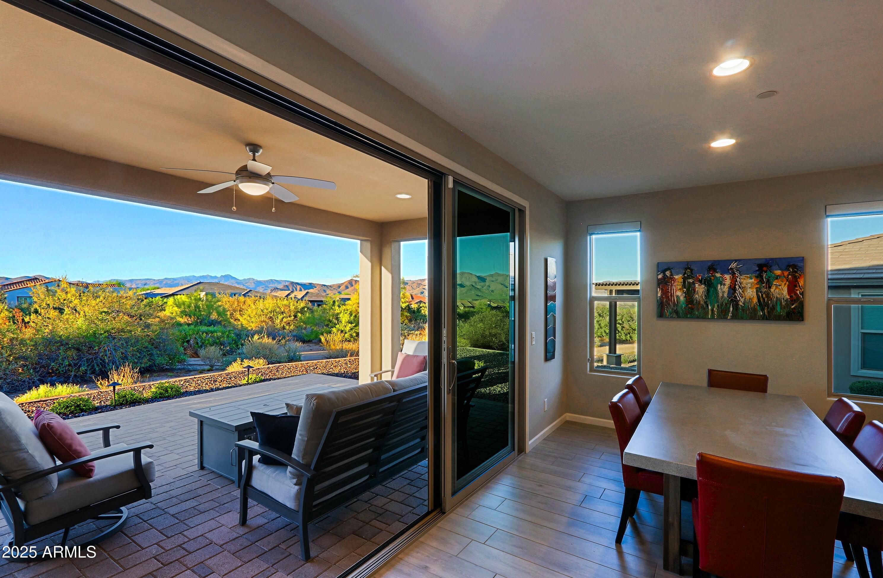 a living room with furniture a rug and a floor to ceiling window
