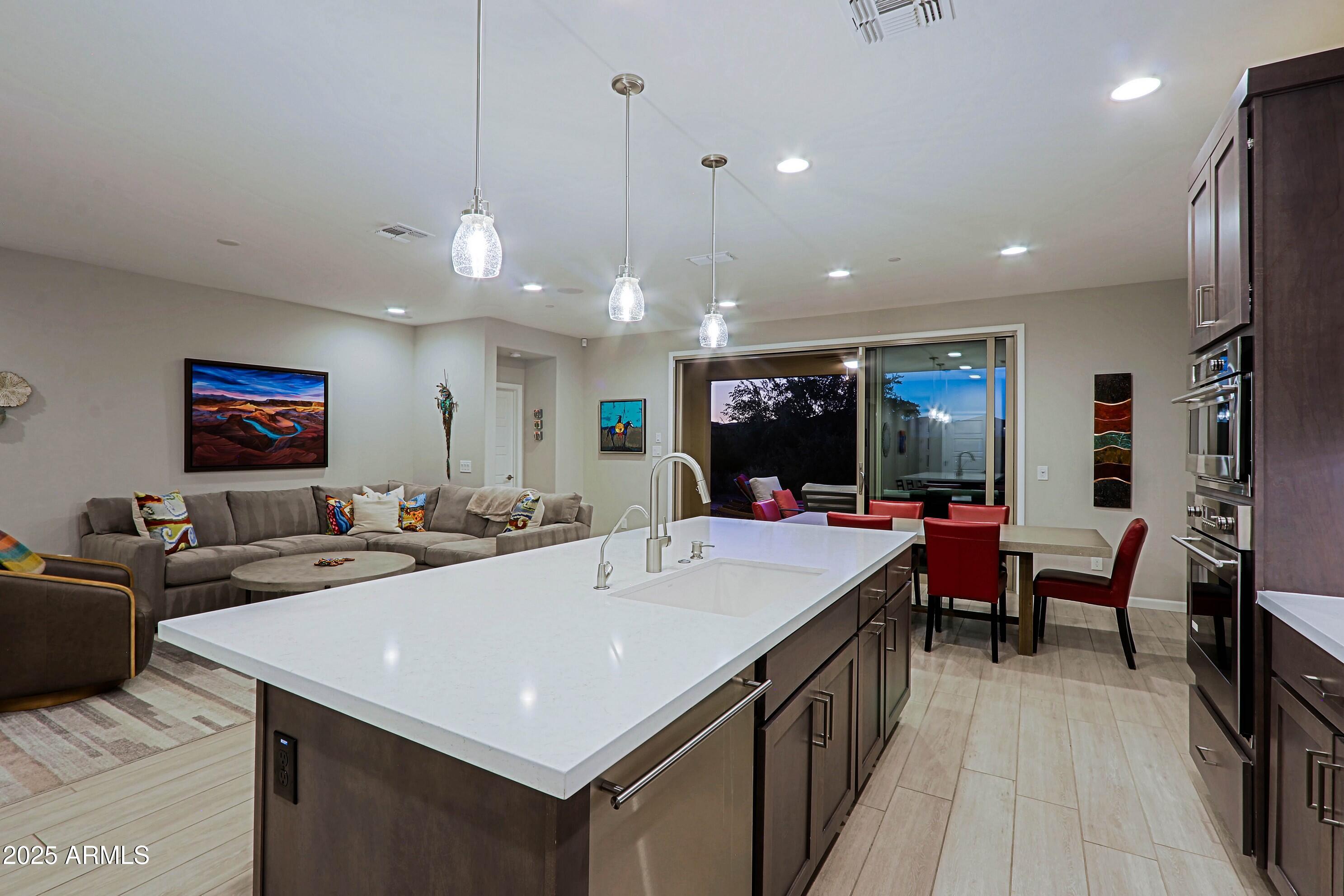 17668 East Chevelon Canyon Circle Rio Verde, AZ 85263 - Photo 16 of 59 a view of a dining room with furniture a chandelier and wooden floor