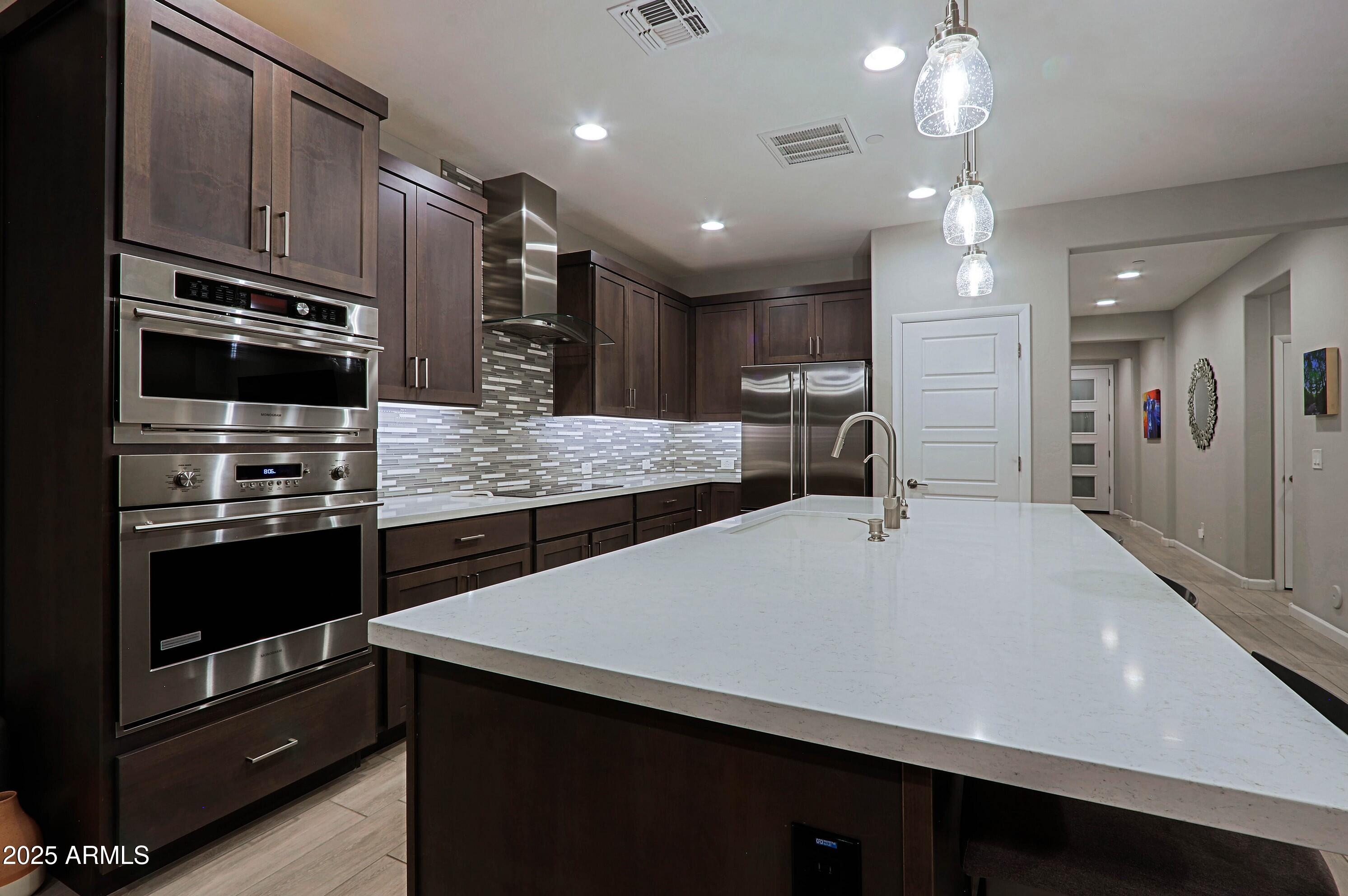 17668 East Chevelon Canyon Circle Rio Verde, AZ 85263 - Photo 17 of 59 a large kitchen with stainless steel appliances a large counter top