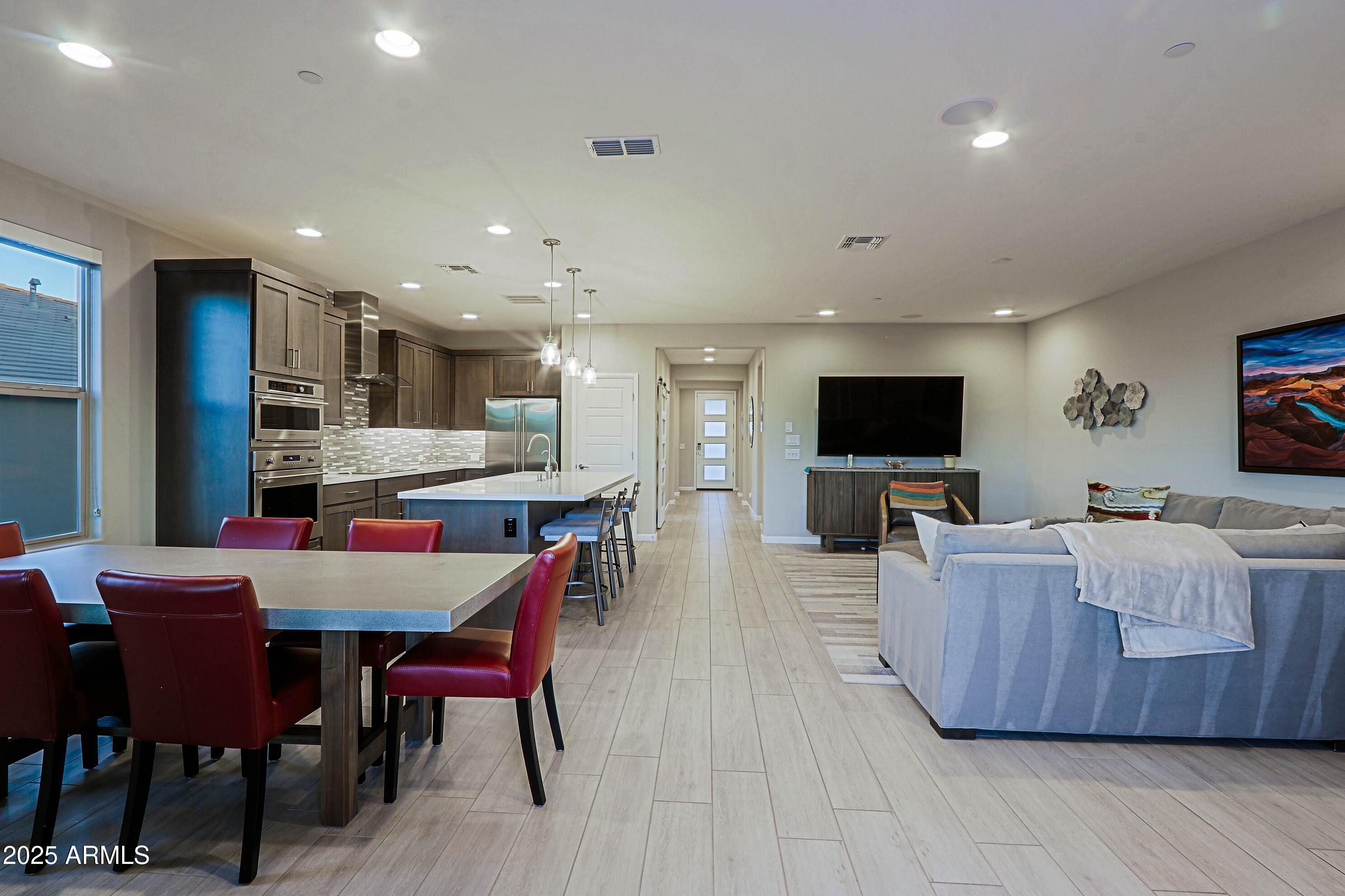 17668 East Chevelon Canyon Circle Rio Verde, AZ 85263 - Photo 20 of 59 a living room with furniture a flat screen tv and kitchen view