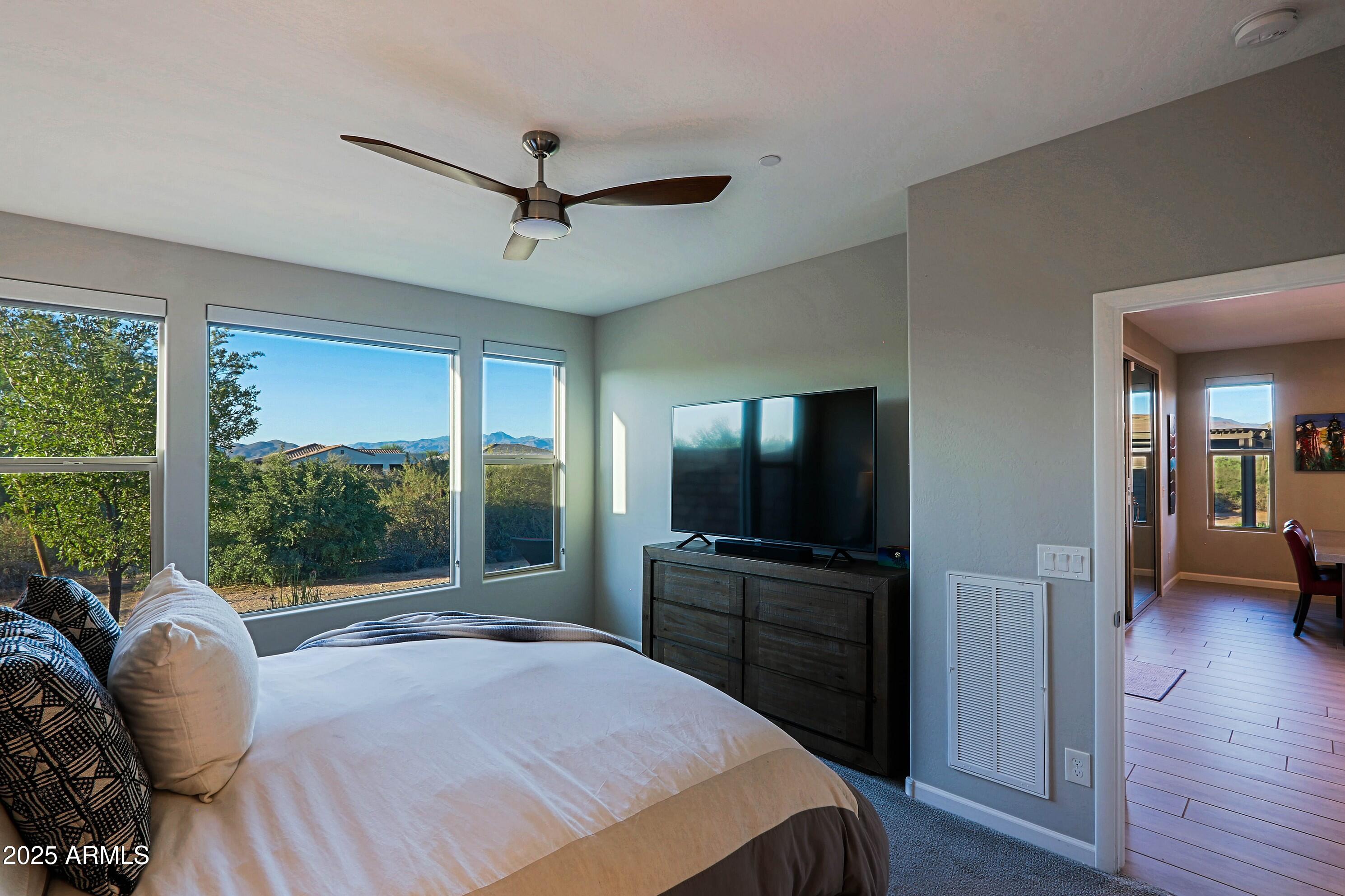 17668 East Chevelon Canyon Circle Rio Verde, AZ 85263 - Photo 22 of 59 a bedroom with a bed and a television
