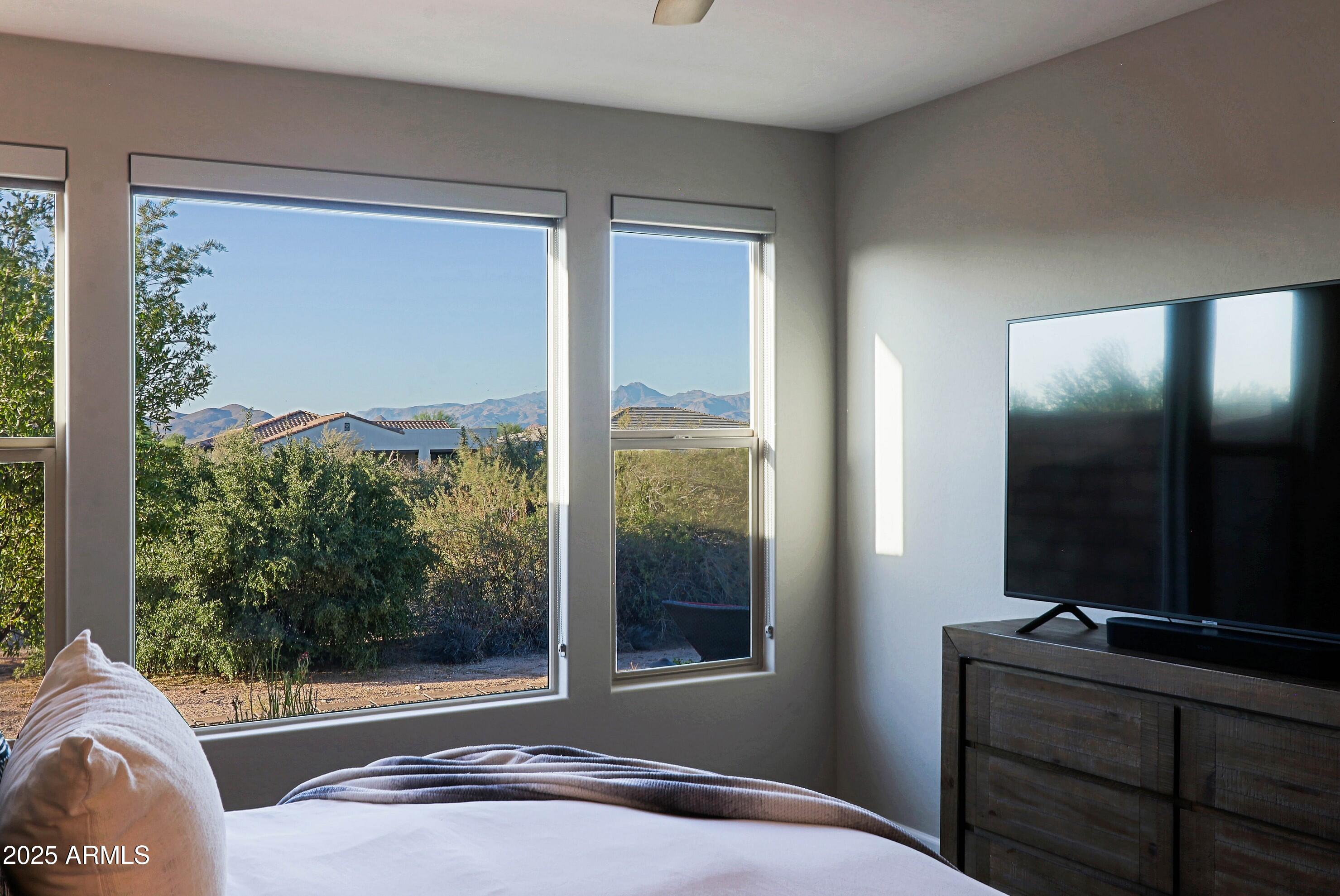 17668 East Chevelon Canyon Circle Rio Verde, AZ 85263 - Photo 23 of 59 a bedroom with a bed and large window