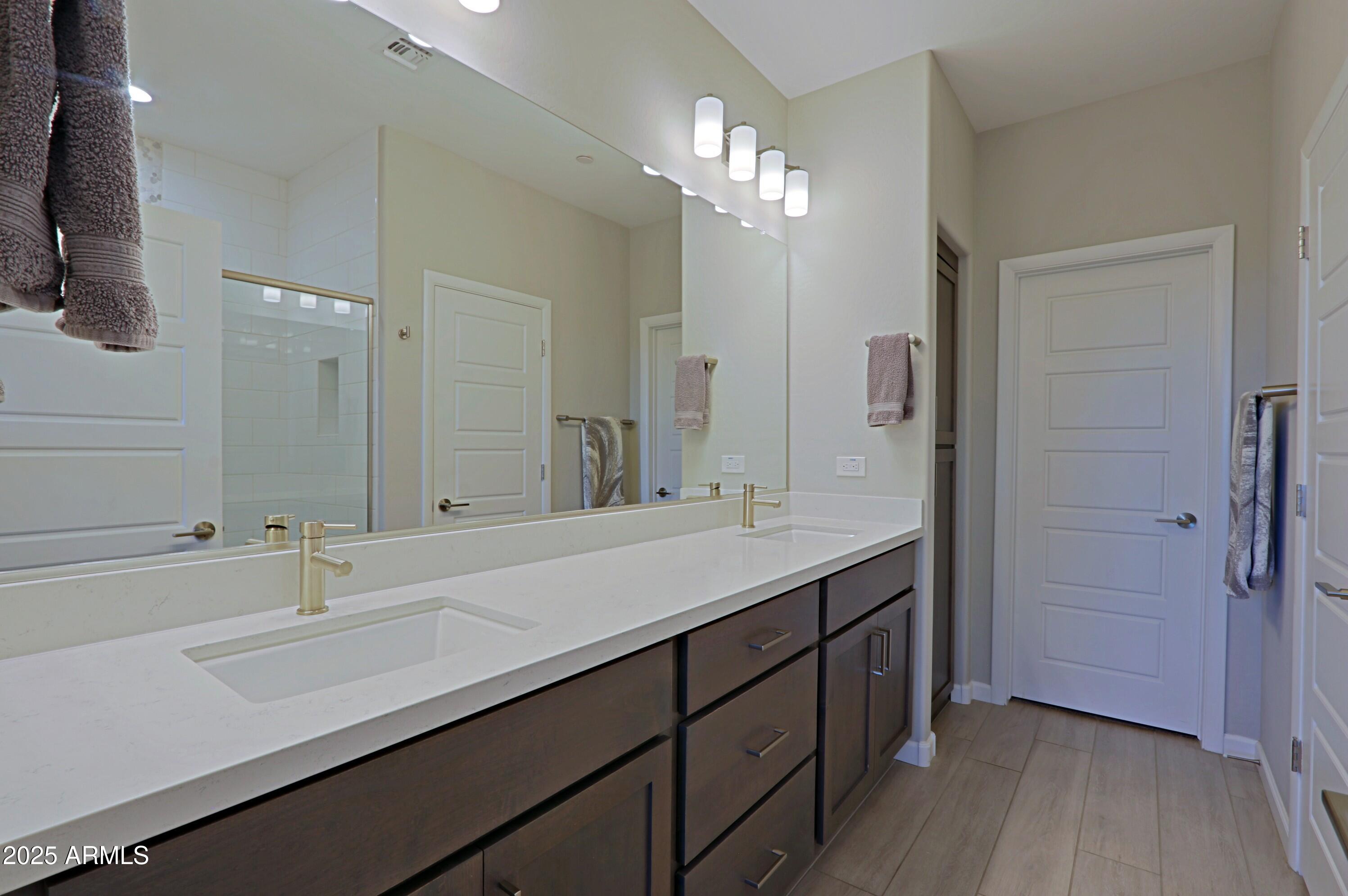 17668 East Chevelon Canyon Circle Rio Verde, AZ 85263 - Photo 25 of 59 a bathroom with a sink double vanity and a mirror