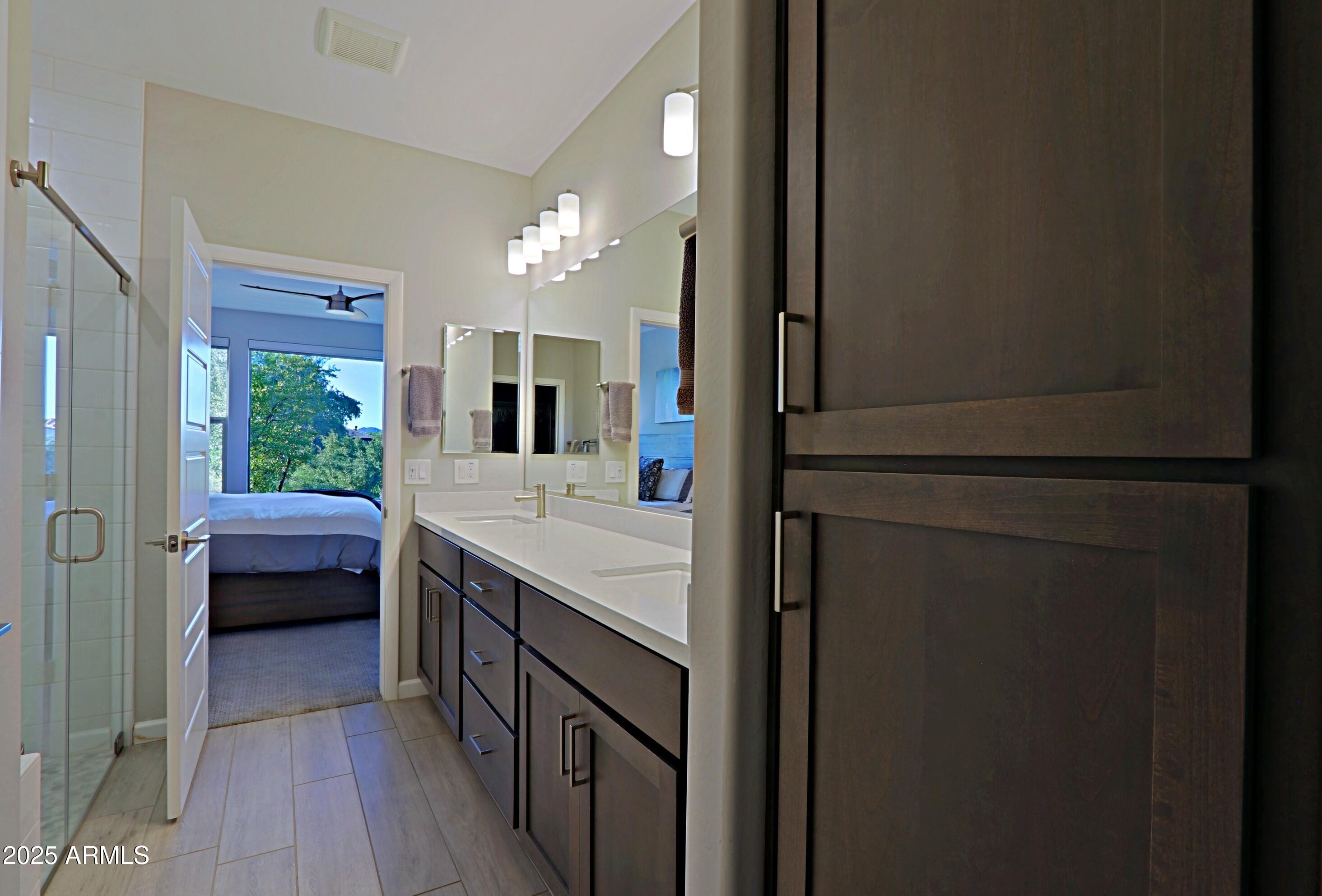 17668 East Chevelon Canyon Circle Rio Verde, AZ 85263 - Photo 26 of 59 a bathroom with a double vanity sink and a mirror