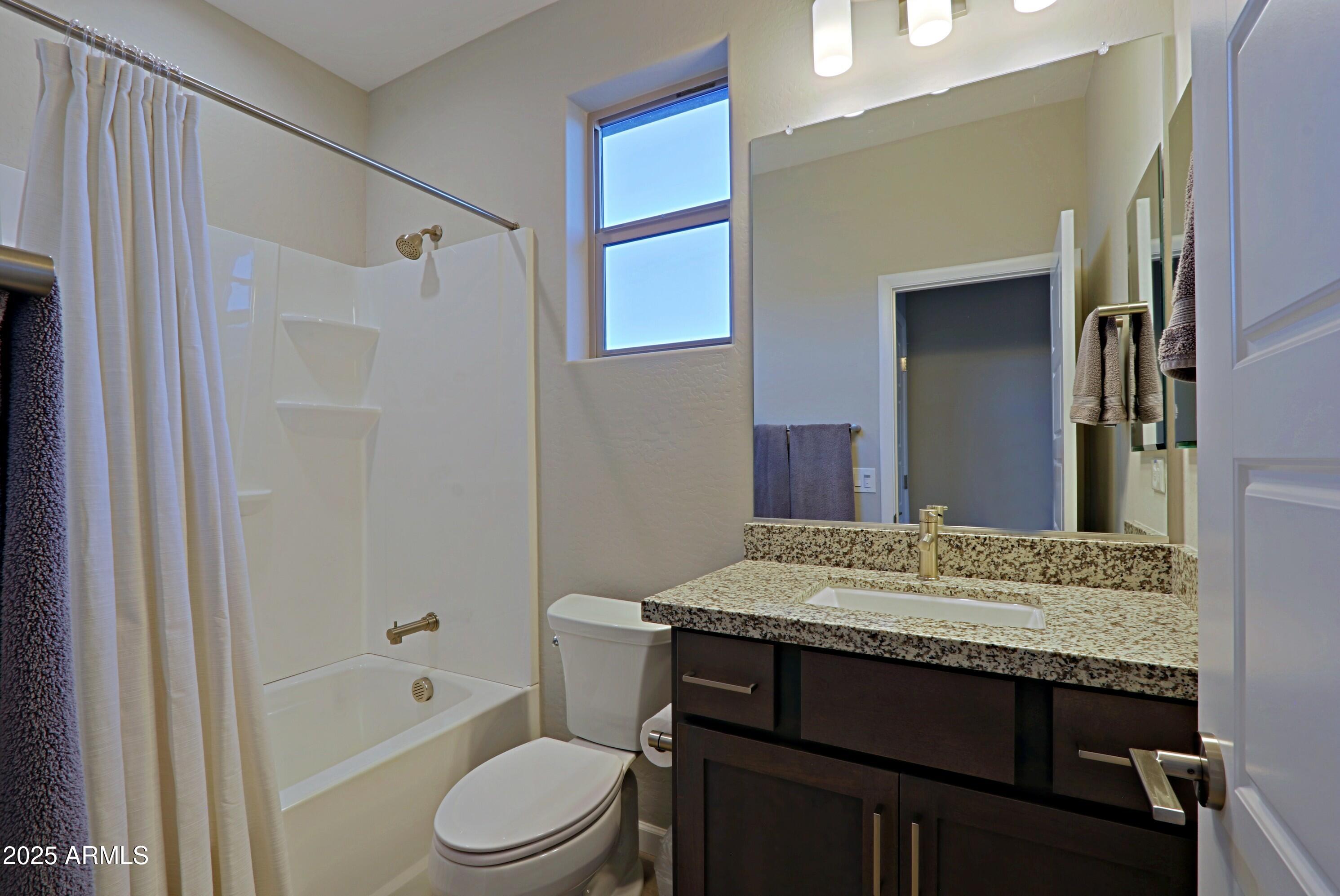 17668 East Chevelon Canyon Circle Rio Verde, AZ 85263 - Photo 29 of 59 a bathroom with a granite countertop sink toilet and shower
