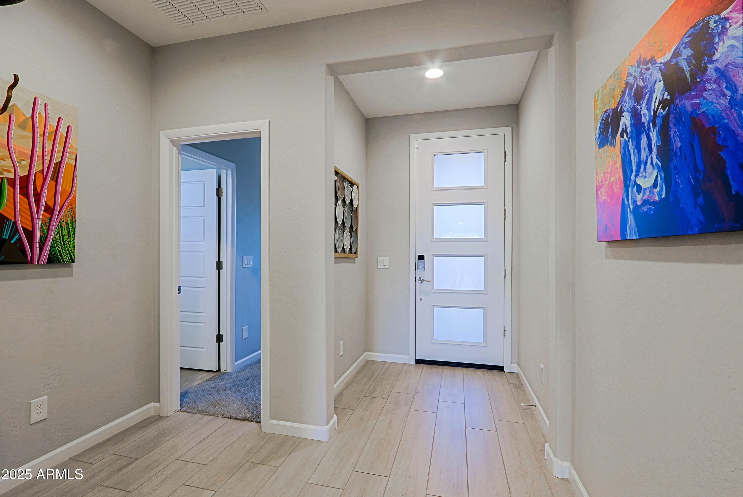17668 East Chevelon Canyon Circle Rio Verde, AZ 85263 - Photo 8 of 59 a view of a hallway with wooden floor and a bathroom