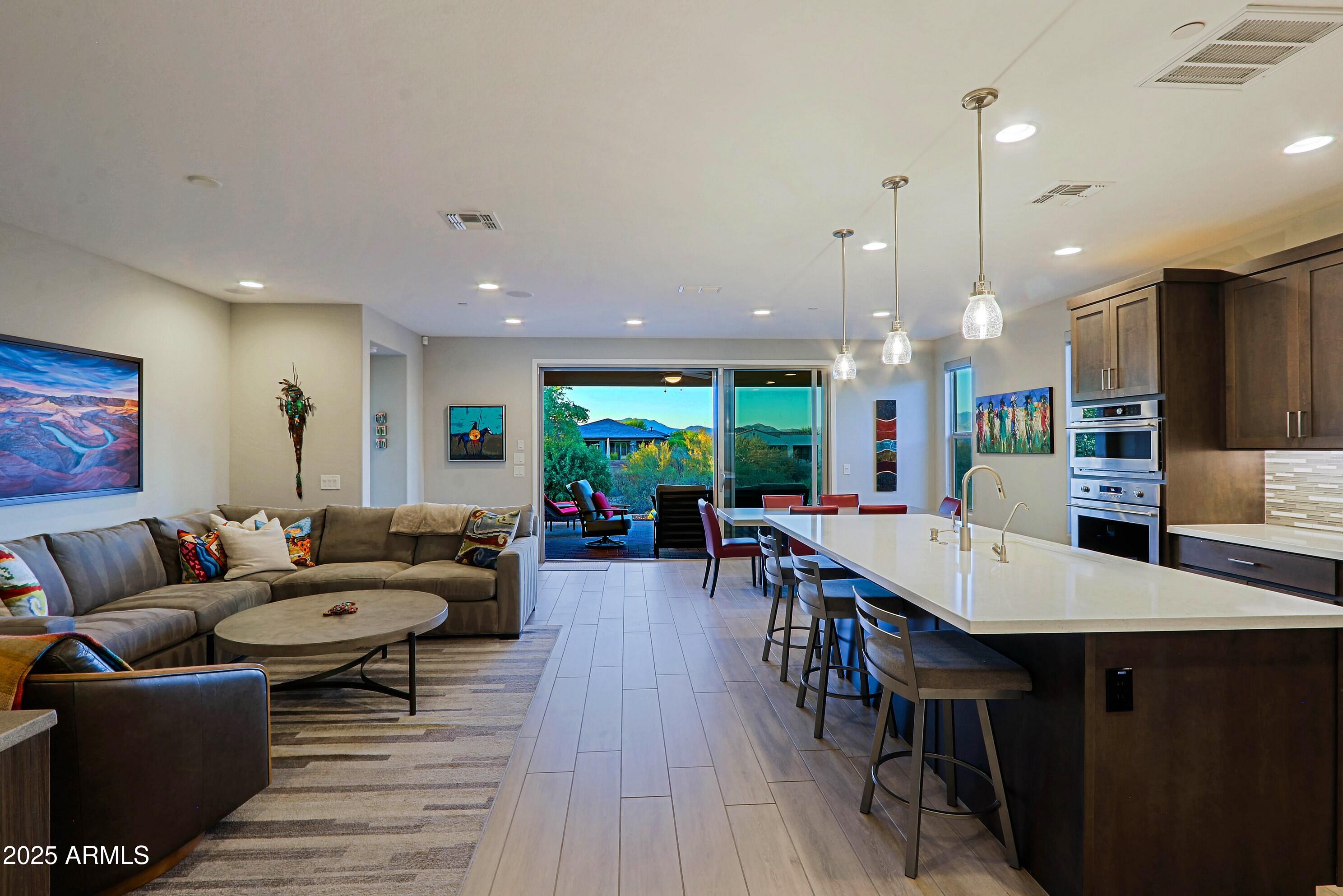 17668 East Chevelon Canyon Circle Rio Verde, AZ 85263 - Photo 10 of 59 a living room with furniture a wooden floor and kitchen view