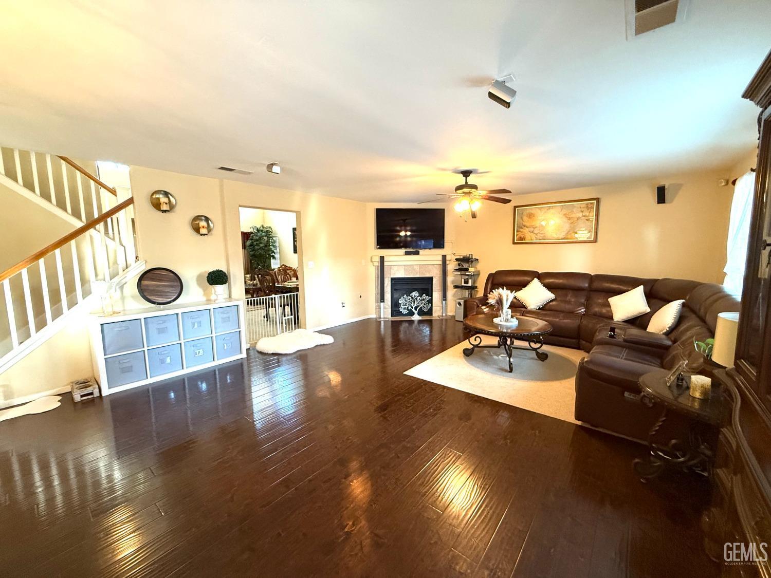 Undisclosed Address Bakersfield, CA 93311 - Photo 23 of 52 a living room with furniture and a wooden floor