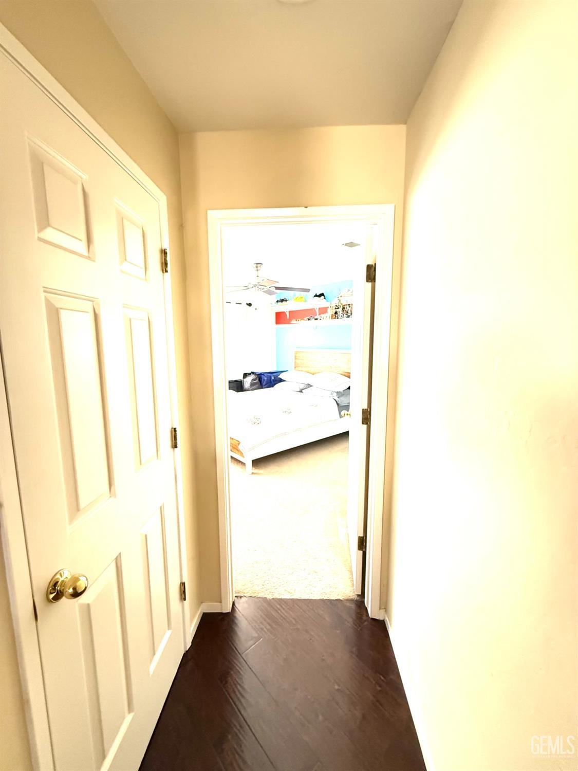 Undisclosed Address Bakersfield, CA 93311 - Photo 39 of 52 a view of a hallway with wooden floor