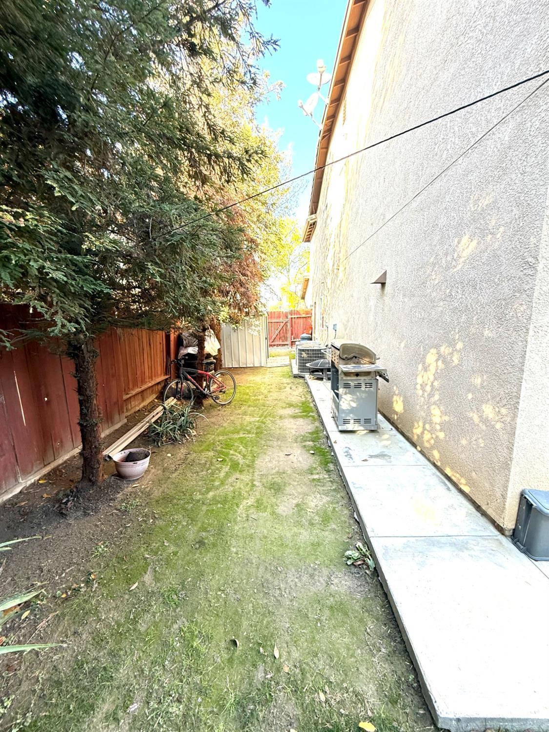 Undisclosed Address Bakersfield, CA 93311 - Photo 50 of 52 a backyard of a house with table and chairs