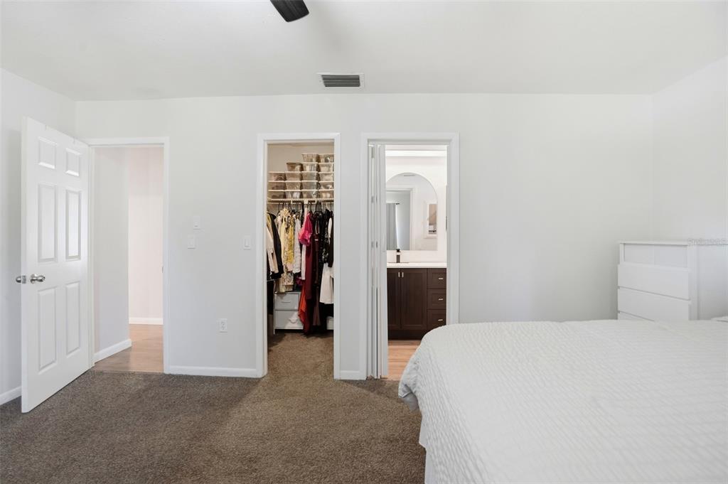 5485 Pinehurst Drive Spring Hill, FL 34606 - Photo 18 of 45 a bedroom with a bed and a walk in closet