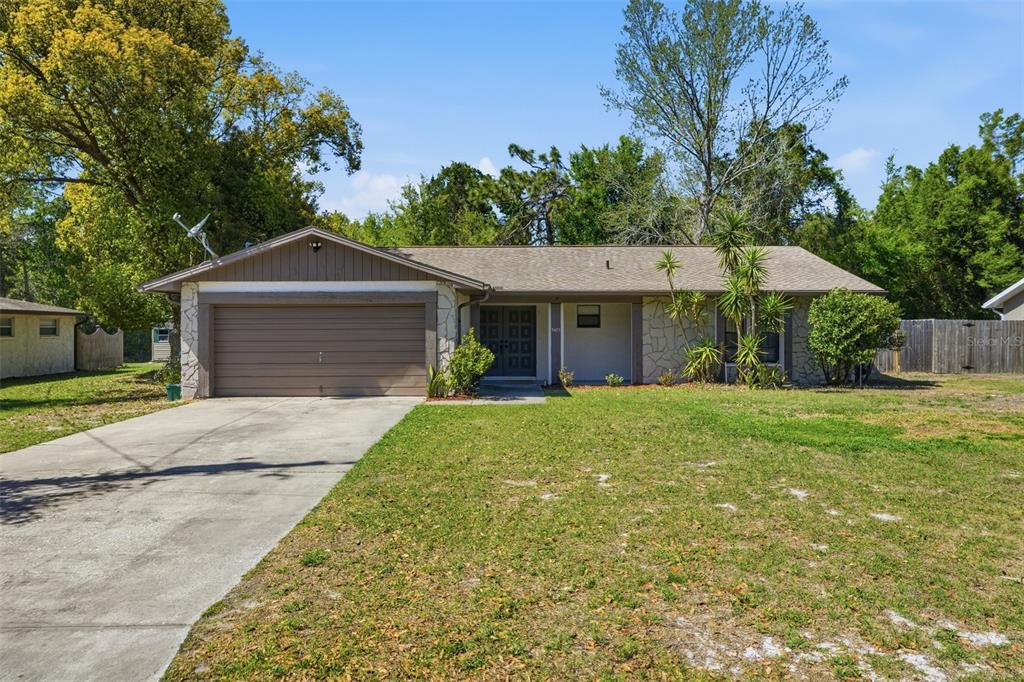 5485 Pinehurst Drive Spring Hill, FL 34606 - Photo 2 of 45 a front view of a house with a yard