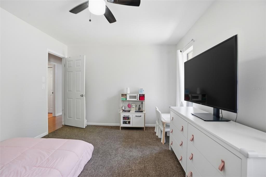5485 Pinehurst Drive Spring Hill, FL 34606 - Photo 21 of 45 a bedroom with a bed and a flat screen tv