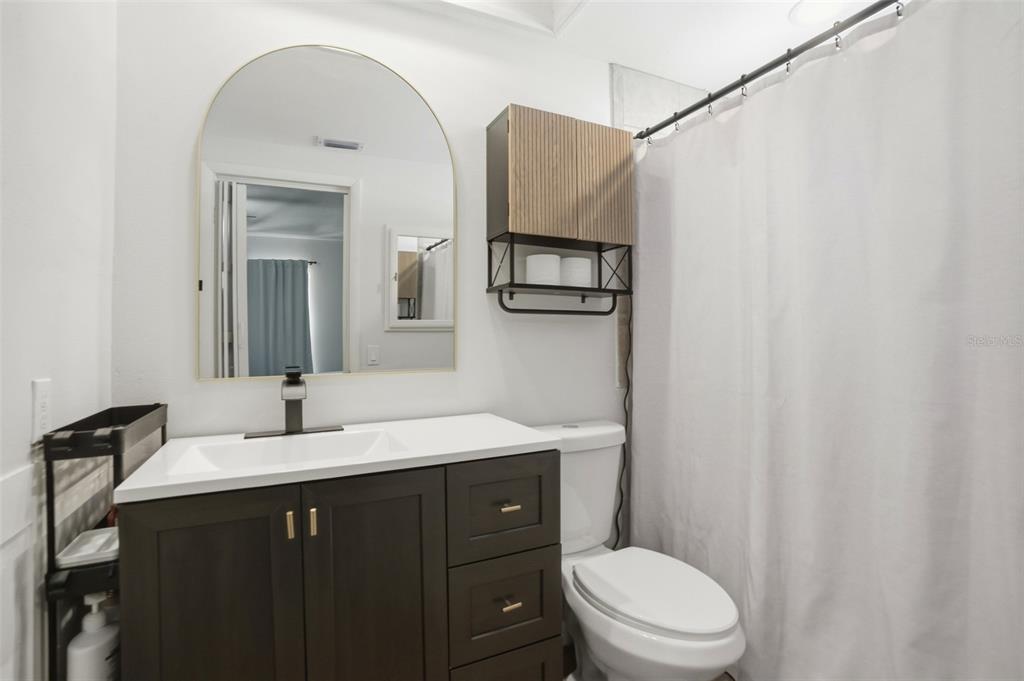 5485 Pinehurst Drive Spring Hill, FL 34606 - Photo 23 of 45 a bathroom with a sink a toilet and mirror