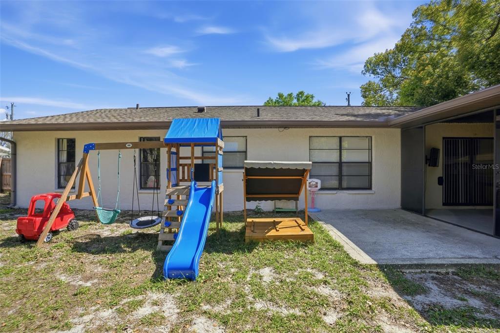 5485 Pinehurst Drive Spring Hill, FL 34606 - Photo 29 of 45 a view of a house with a swimming pool and sitting area