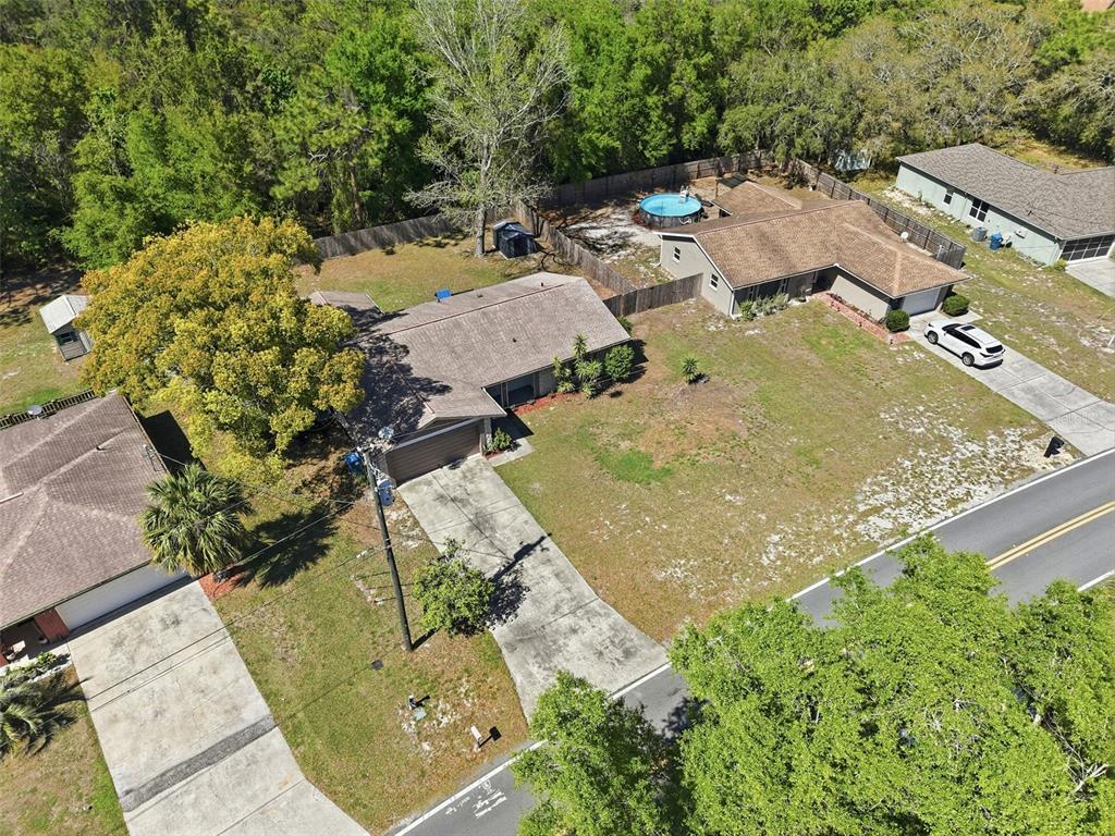 5485 Pinehurst Drive Spring Hill, FL 34606 - Photo 38 of 45 an aerial view of a house with a yard and lake view