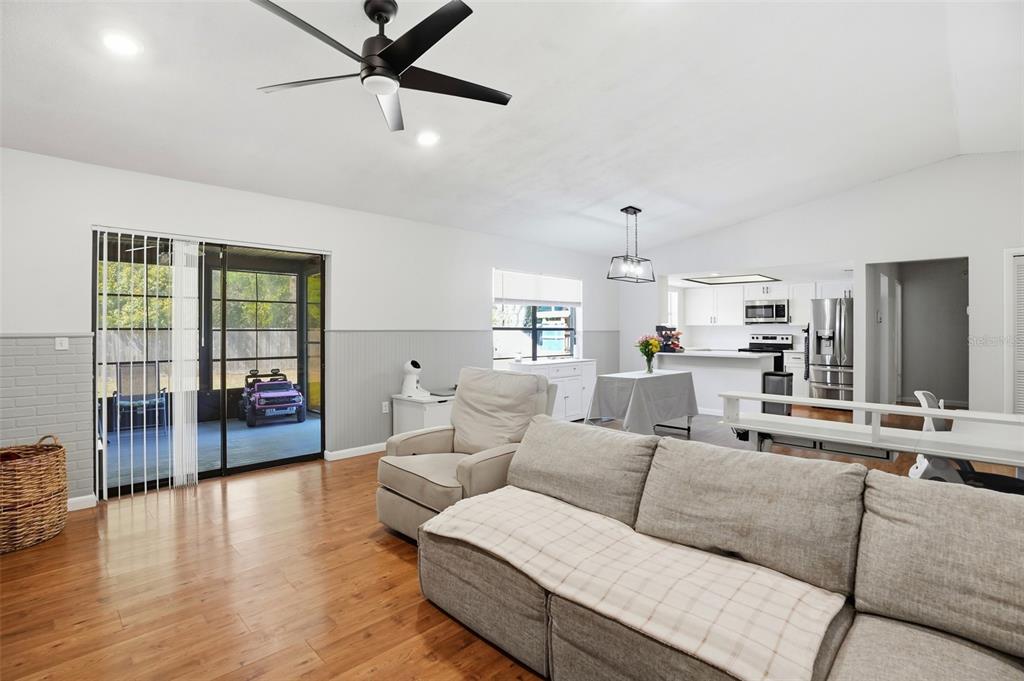 5485 Pinehurst Drive Spring Hill, FL 34606 - Photo 5 of 45 a living room with furniture and a wooden floor