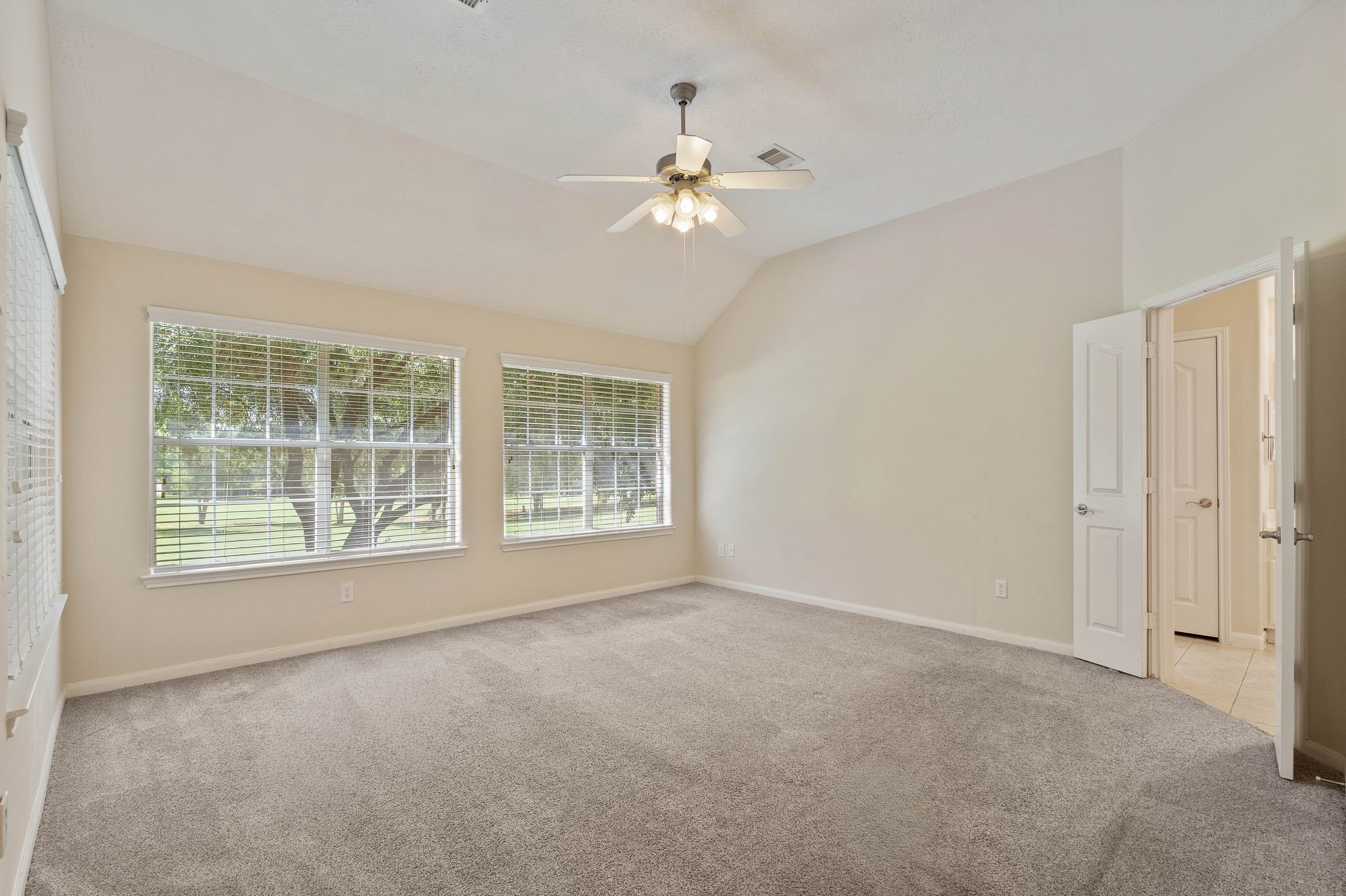 166 April Cove Montgomery, TX 77356 - Photo 16 of 37 Private primary suite offering generous space, high ceilings, and peaceful views.