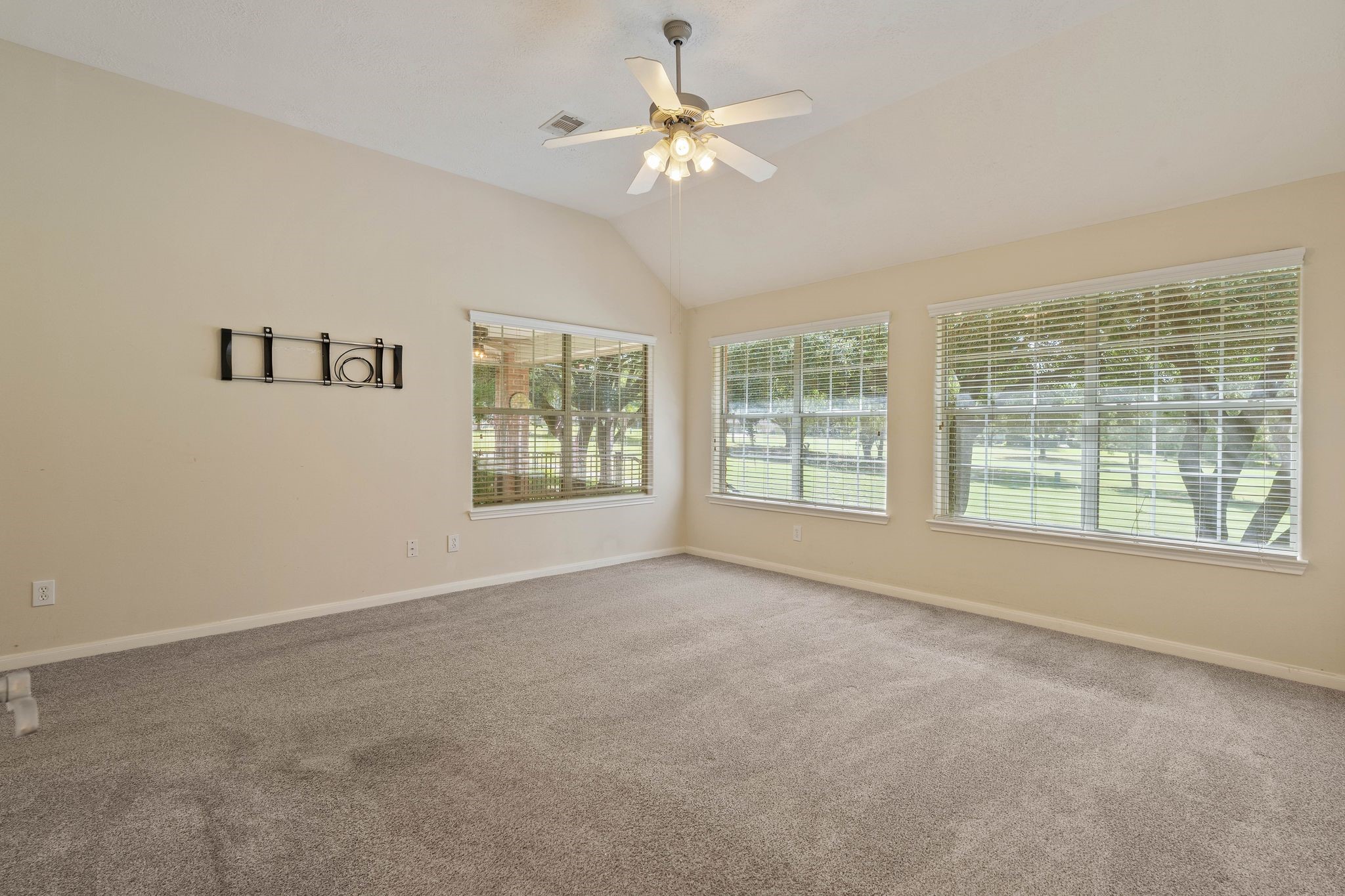 166 April Cove Montgomery, TX 77356 - Photo 17 of 37 Bright and airy primary bedroom with neutral finishes and plush carpeting.