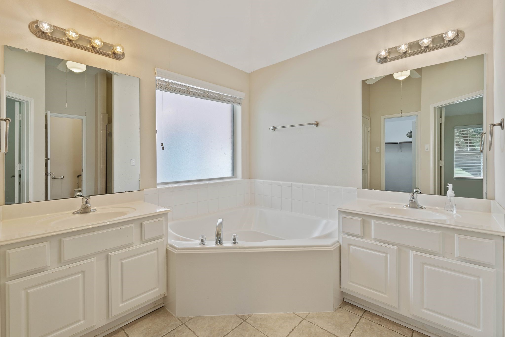 166 April Cove Montgomery, TX 77356 - Photo 20 of 37 Spa-like primary bath featuring double sinks, soaking tub, separate shower, and a spacious walk-in closet.