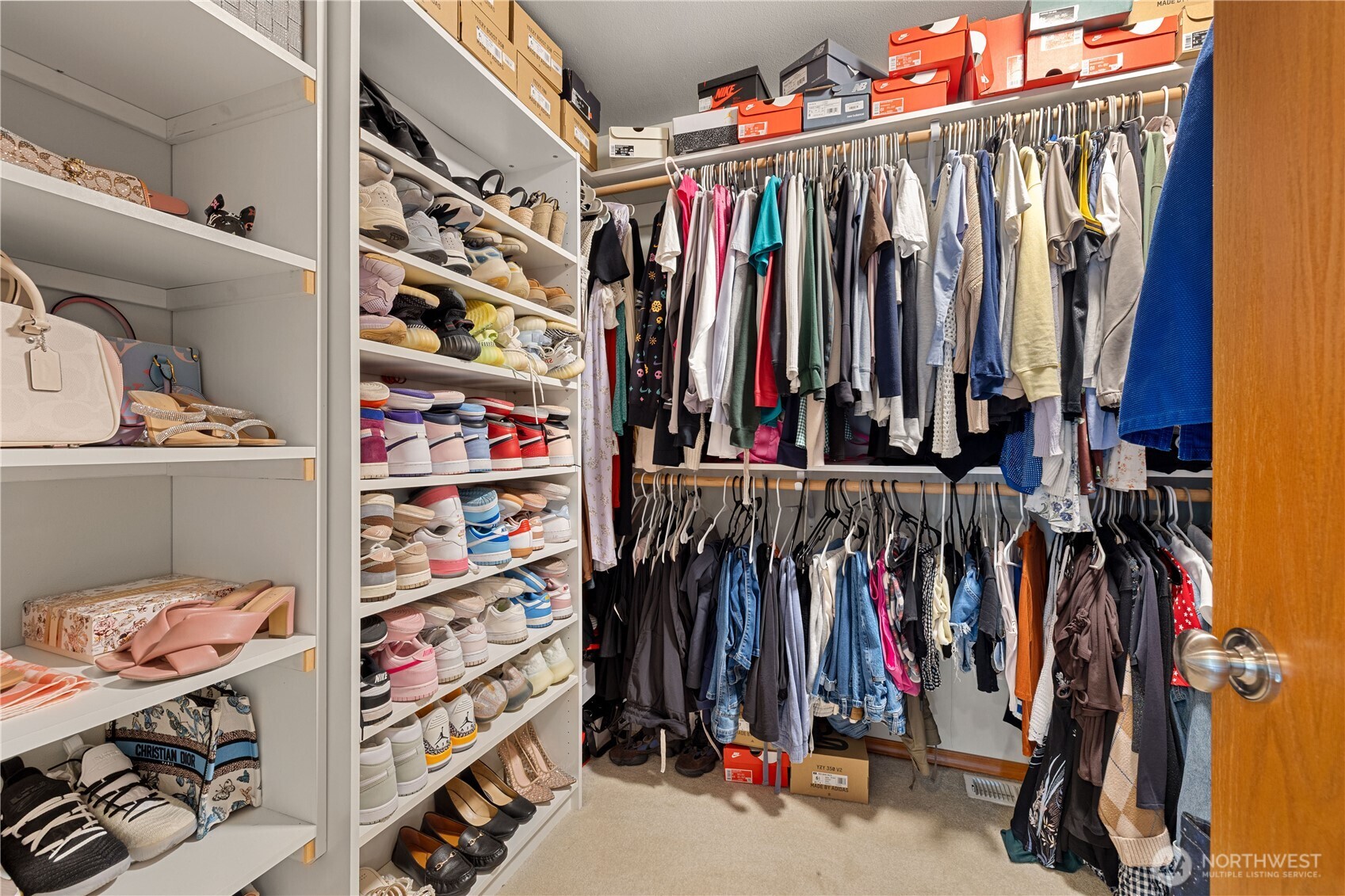 9301 53rd Avenue South Seattle, WA 98118 - Photo 11 of 25 a view of walk in closet with clothes