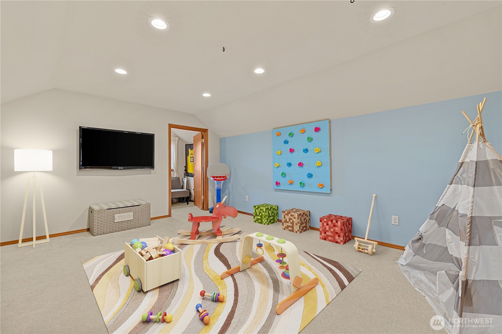 9301 53rd Avenue South Seattle, WA 98118 - Photo 12 of 25 a bedroom with a bed and a flat screen tv