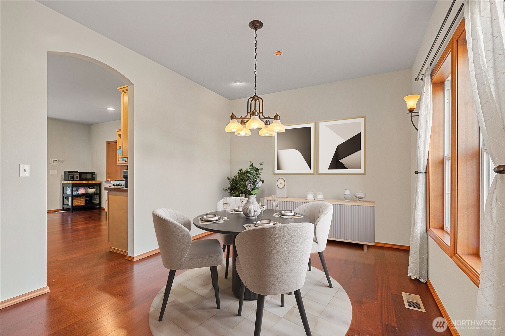 9301 53rd Avenue South Seattle, WA 98118 - Photo 20 of 25 a dining room with furniture a chandelier and wooden floor