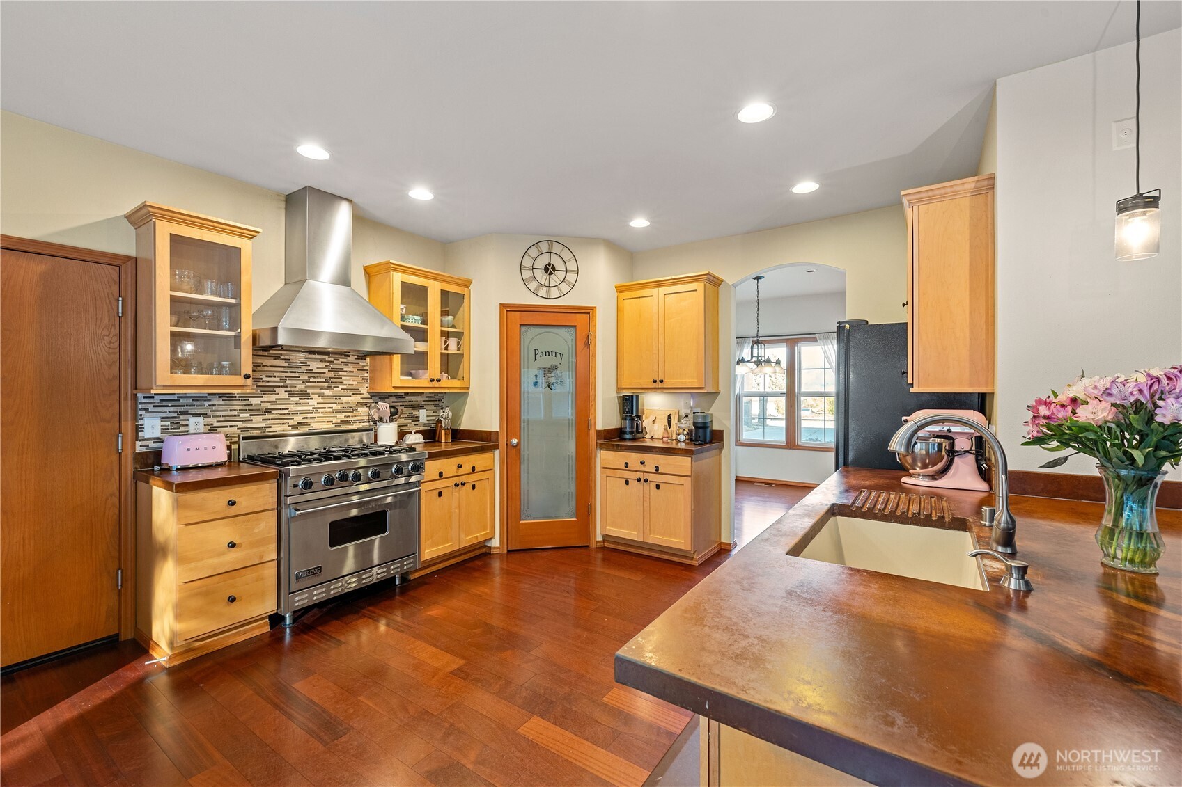 9301 53rd Avenue South Seattle, WA 98118 - Photo 2 of 25 a kitchen with stainless steel appliances granite countertop sink stove and refrigerator