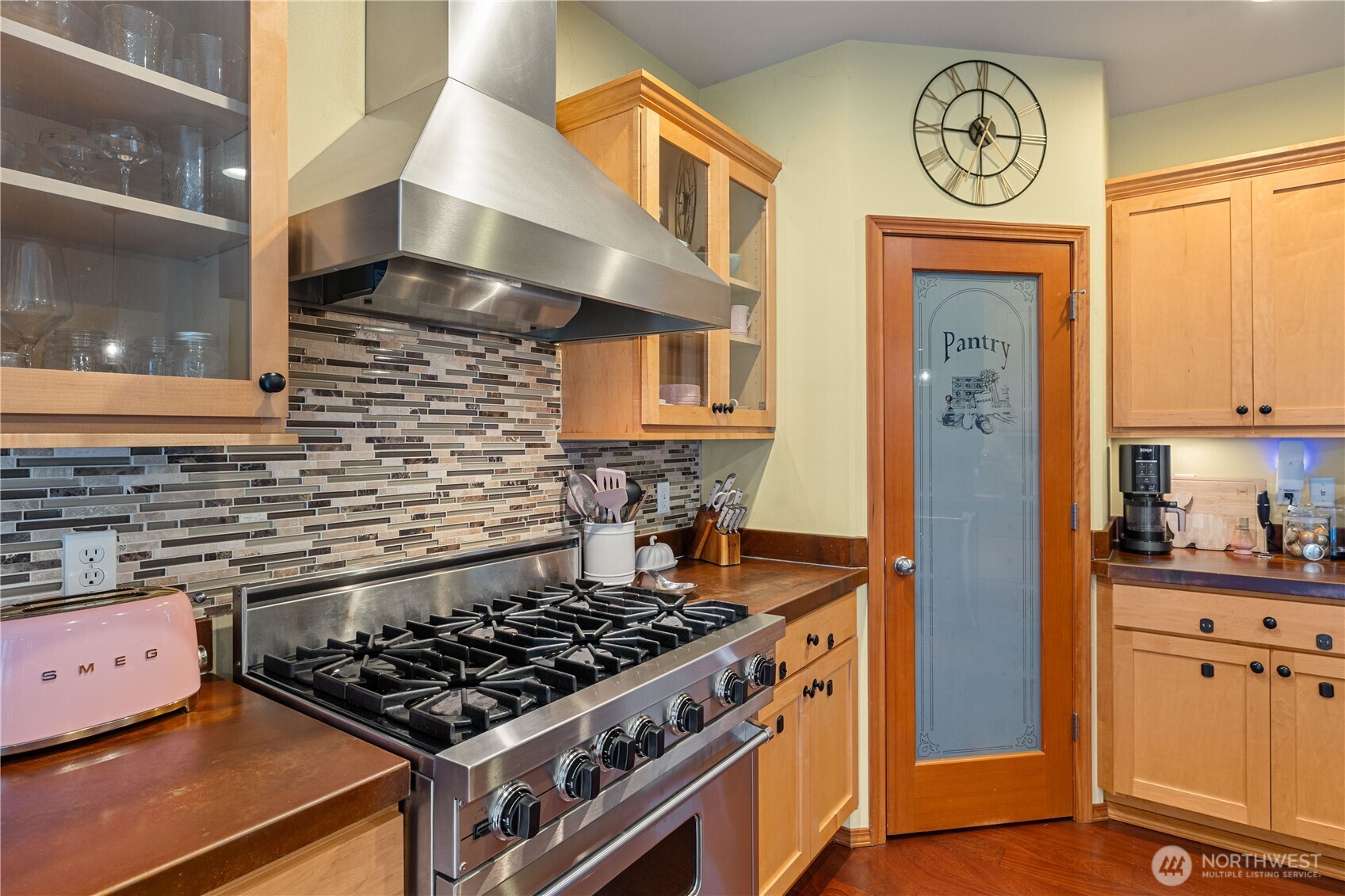 9301 53rd Avenue South Seattle, WA 98118 - Photo 4 of 25 a kitchen with stainless steel appliances granite countertop a stove and a refrigerator