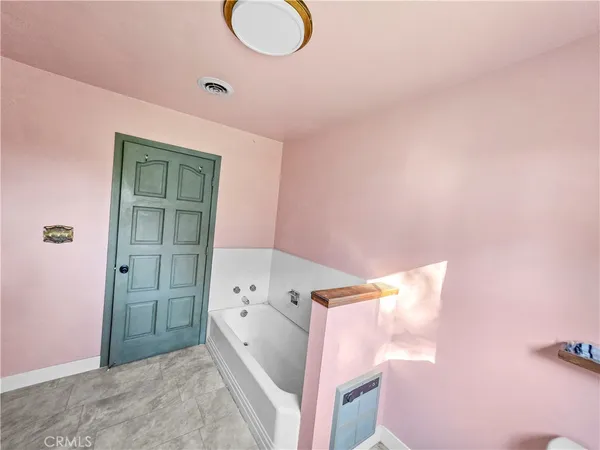 a bathroom with a toilet and a mirror