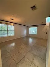 an empty room with windows and entrance