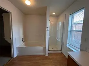 a spacious bathroom with a bathtub and a shower