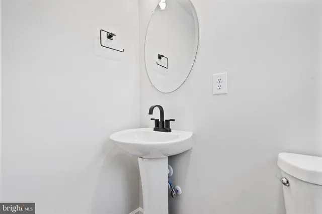 a bathroom with a sink a mirror and a toilet
