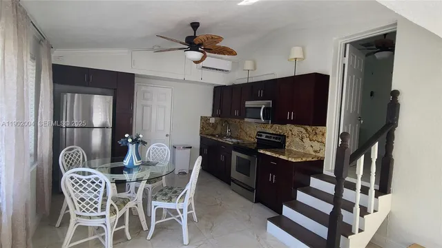 a dining room with furniture and window