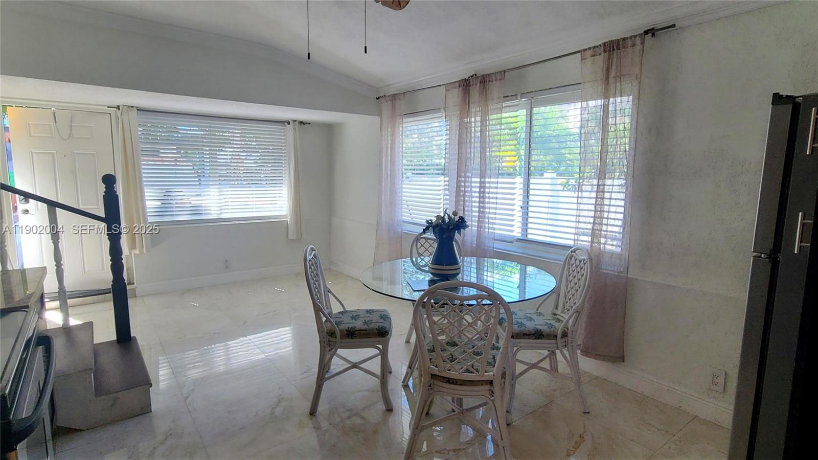 3221 Northeast 7th Street, Unit 2 Pompano Beach, FL 33062 - Photo 4 of 10 a view of a dining room with furniture window and outside view