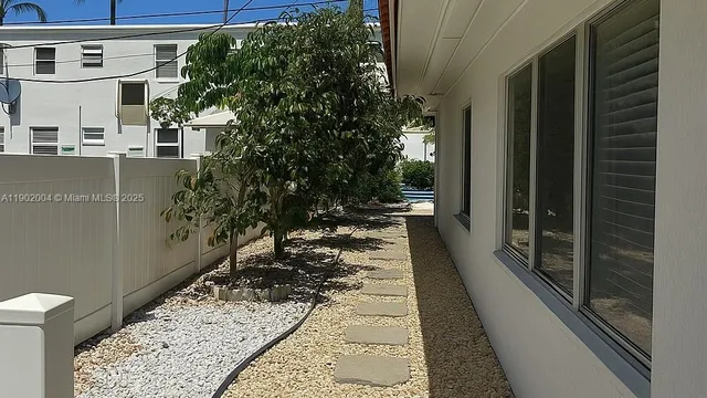 a view of a pathway of a house with a yard