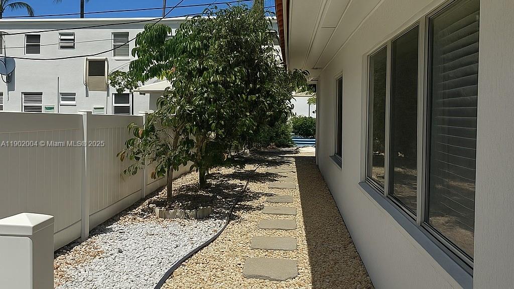 3221 Northeast 7th Street, Unit 2 Pompano Beach, FL 33062 - Photo 8 of 10 a view of a pathway of a house with a yard